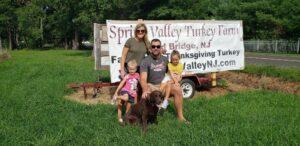 Owners of Spring Valley Turkey Farm with their dog at their veteran-owned farm in Old Bridge, New Jersey.