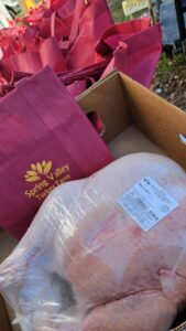 Fresh whole turkey packaged and ready for pickup with Spring Valley Turkey Farm bags
